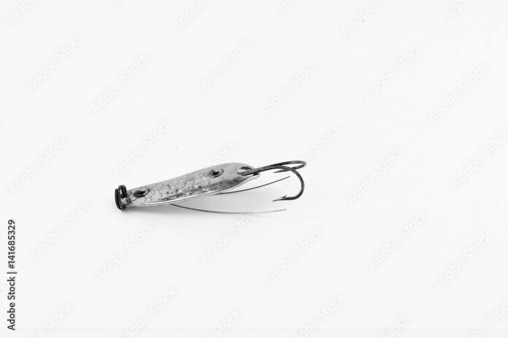 Exhibition of pirated copies of fishing metal spoon baits. Bait for fishing in the shape of a spoon with a hook on a white background. 03/09/2017 Zhitomir. Exhibition of pirated copies of fishing metal spoon baits. Bait for fishing in the shape of a spoon with a hook on a white background. 03/09/2017 Zhitomir.