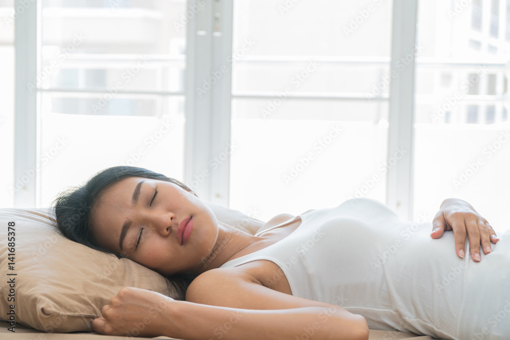 Beautiful young woman sleeping in bed happily. Beautiful young woman sleeping in bed happily.