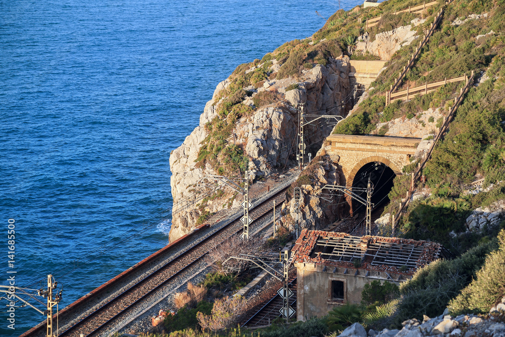 The Mediterranean sea and the railway tunnel near the town of El Garraf. Catalonia, Spain.