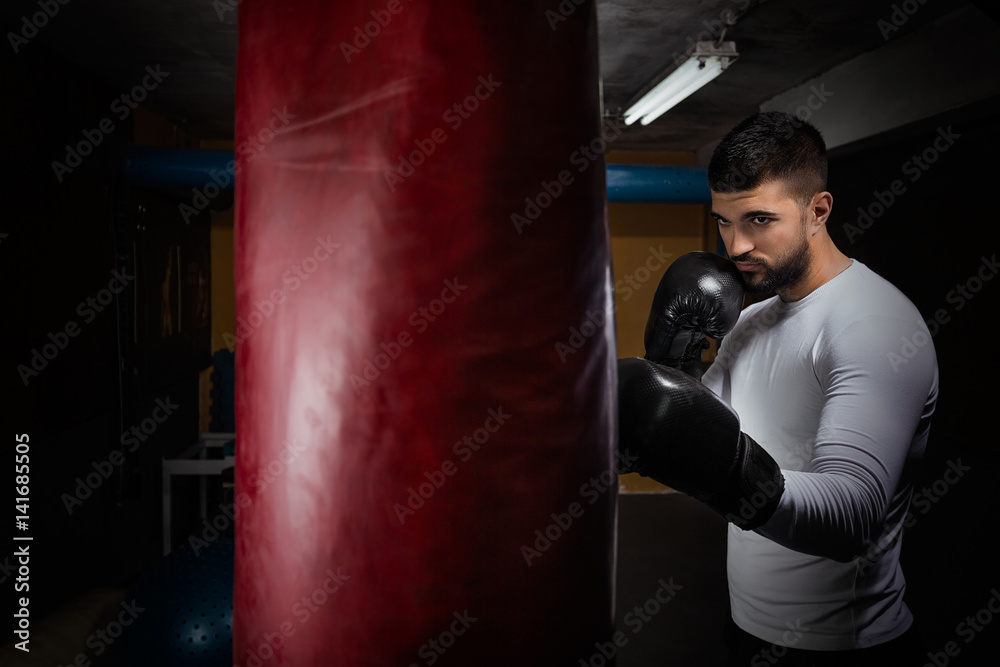 Portrait of young man having kickboxing training at the gym