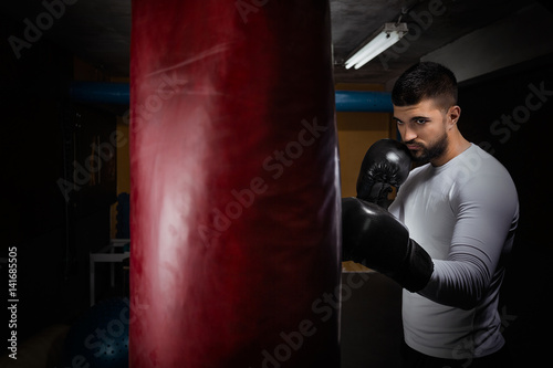 Portrait of young man having kickboxing training at the gym © bokan
