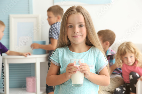 Cute little girl holding gl...