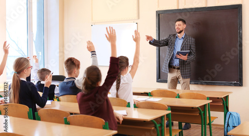 Pupils listening teacher an...