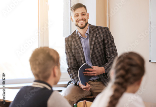 Pupils listening teacher in...