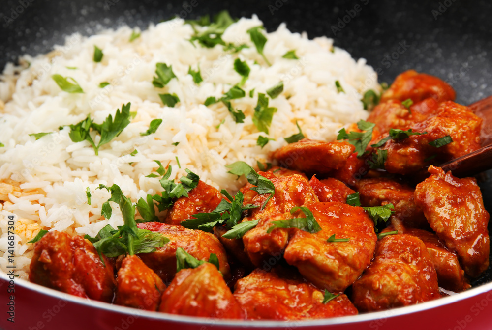 Fototapeta premium Frying pan with tasty chicken tikka masala and rice, closeup