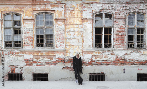 Hipster girl in black  in front of old ruin house © qunamax