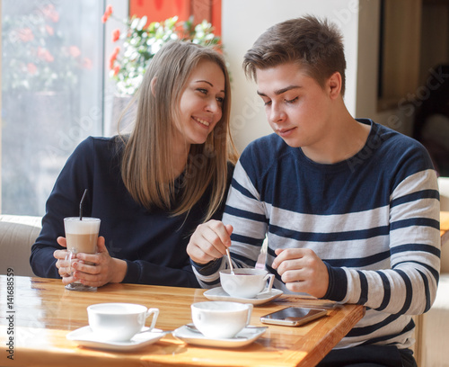 Cheerful couple dating in a cafe.  They look happy