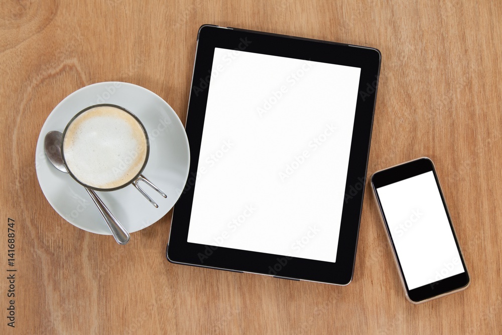 Cup of coffee with digital table and mobile phone Cup of coffee with digital table and mobile phone