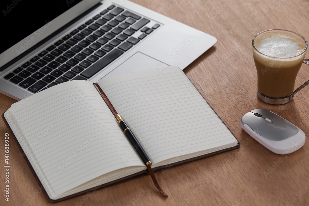 Cup of coffee with laptop, mouse, pen and organizer Cup of coffee with laptop, mouse, pen and organizer