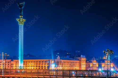 Maidan Nezalezhnosti (literally: Independence Square) is the central square of the capital city of Ukraine with people in the night time. Vivid, splittoned image. photo