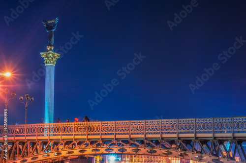 Maidan Nezalezhnosti (literally: Independence Square) is the central square of the capital city of Ukraine with people in the night time. Vivid, splittoned image. photo