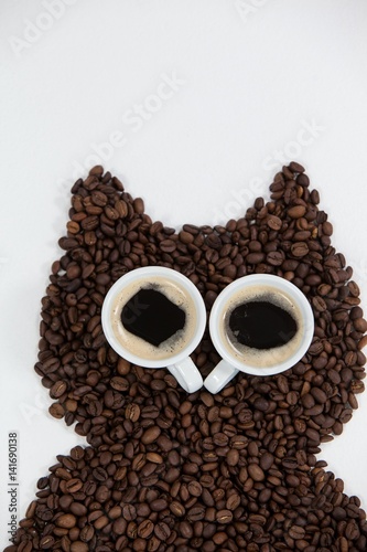 Coffee beans and cups forming owl