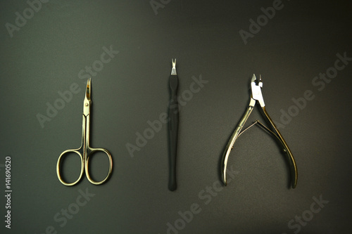 Manicure tools on the black background