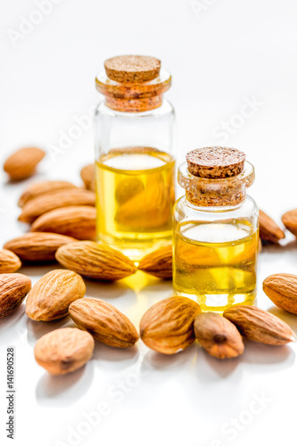 natural oil and almond in cosmetic set on table background