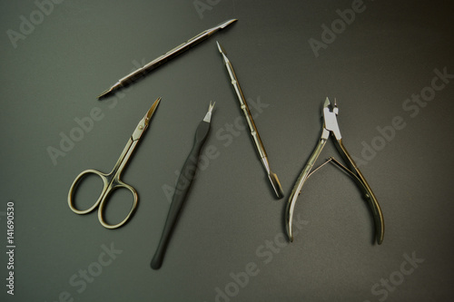 Manicure tools on the black background