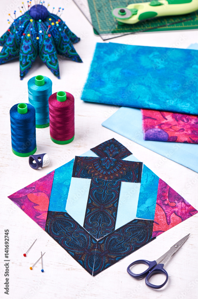Fototapeta premium Sewing patchwork of block anchor surrounded by accessories