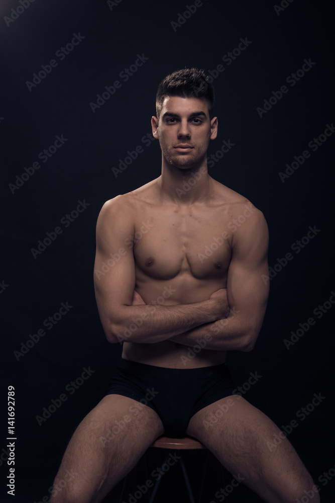 Fototapeta premium one young man, shirtless body posing sitting
