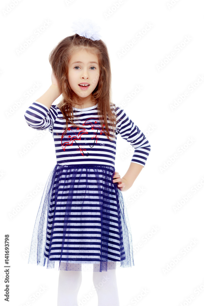 Cute little girl posing in front of the camera. Cute little girl posing in front of the camera.