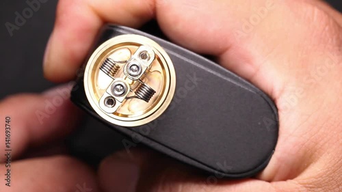 test burning the new dual kanthal micro coils on the atomizer deck base of electronic cigarette for vaping, close up scene, high definition, Full HD, 1920x1080