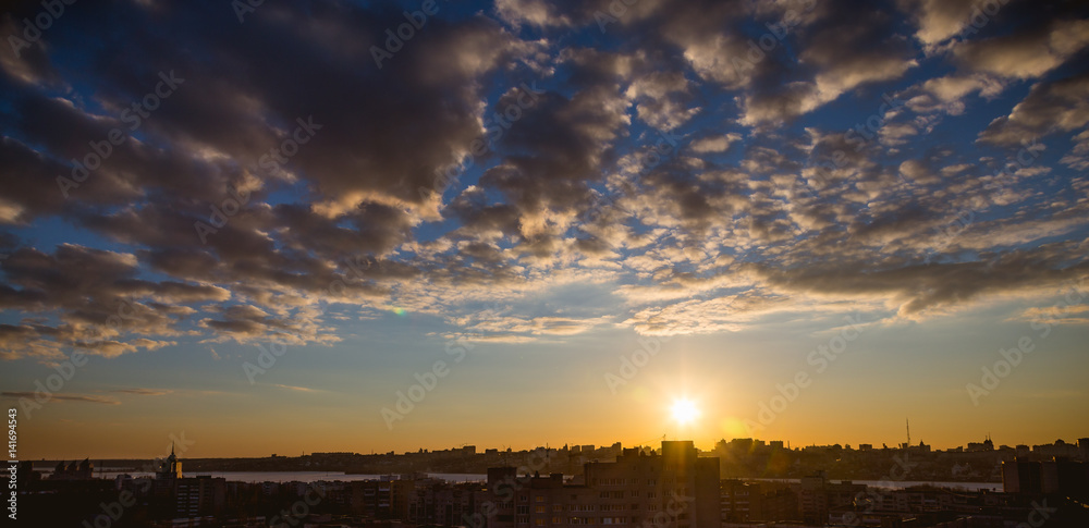 Fototapeta premium Aerial panoramic ramatic view from rooftop of cityscape in sunset time 