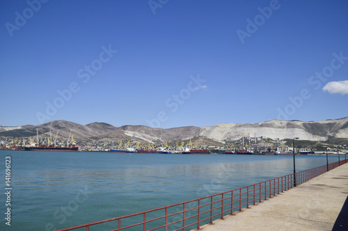 Cargo port with port cranes. Sea bay and mountainous coast. © eleonimages