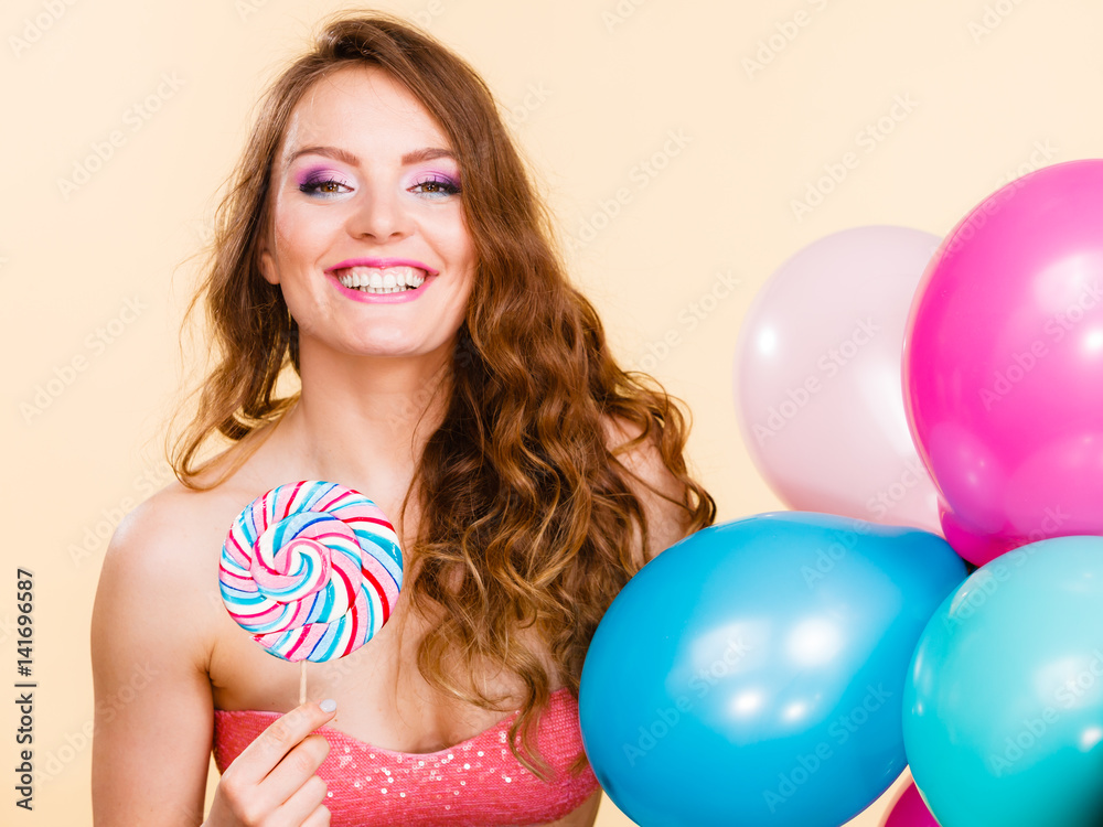 Woman holds lollipop candy and balloons Woman holds lollipop candy and balloons
