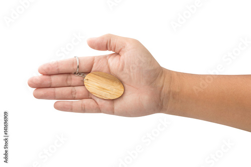 hand holding wooden Keychain isolated on white background