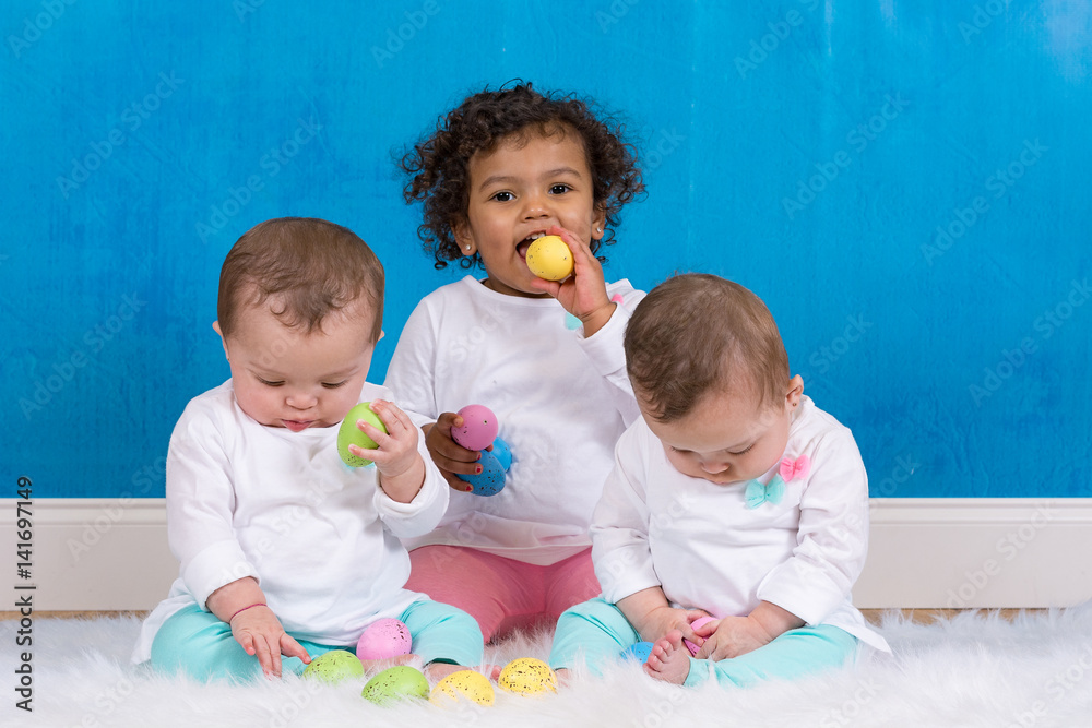 Big sister sitting with her identical twin sisters Big sister sitting with her identical twin sisters