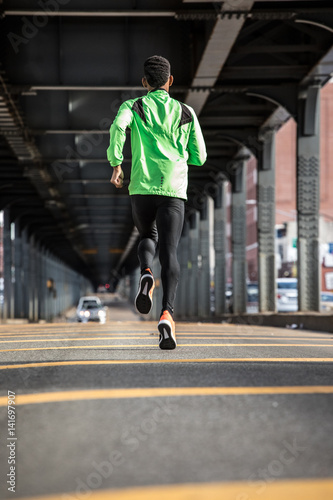 A young, black man goes for a jog in the streets of Brooklyn, NYC