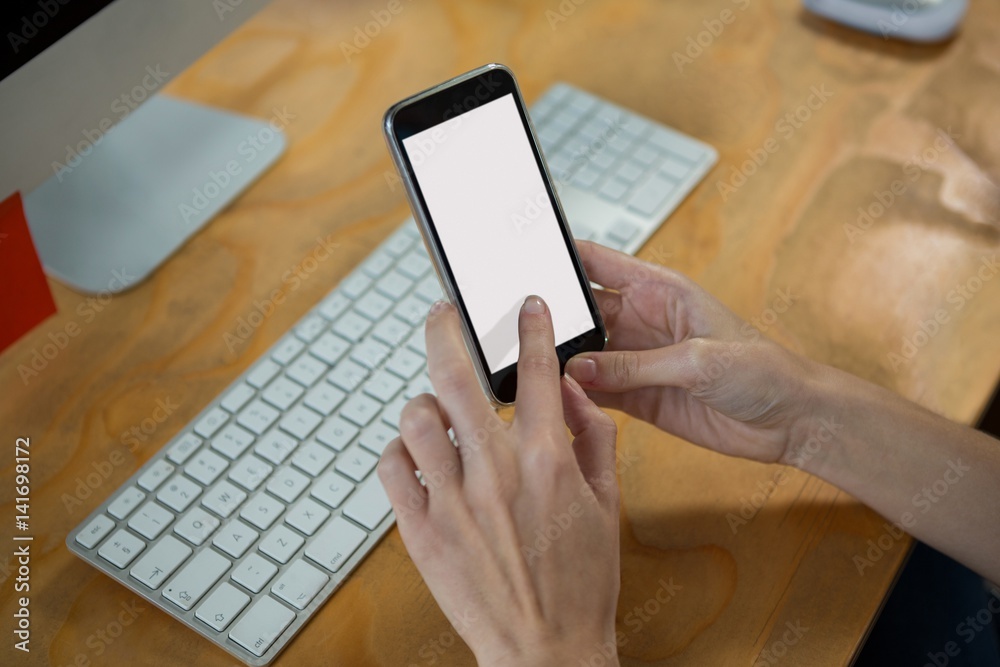 Hand of female graphic designer using mobile phone Hand of female graphic designer using mobile phone