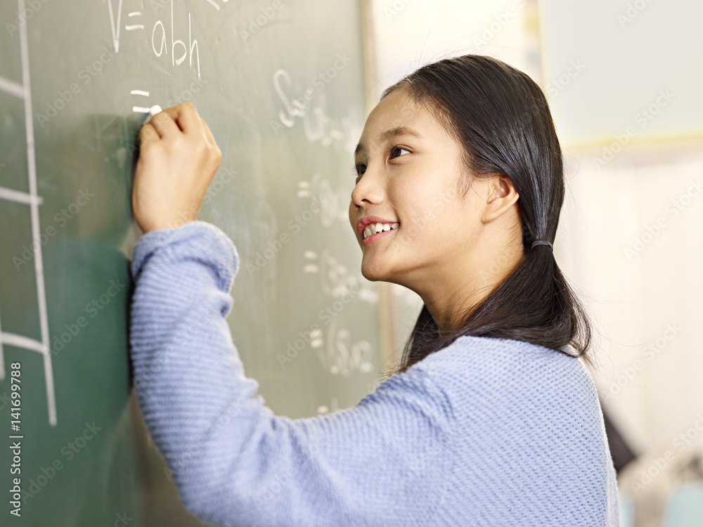 asian elementary school student solving a math problem asian elementary school student solving a math problem