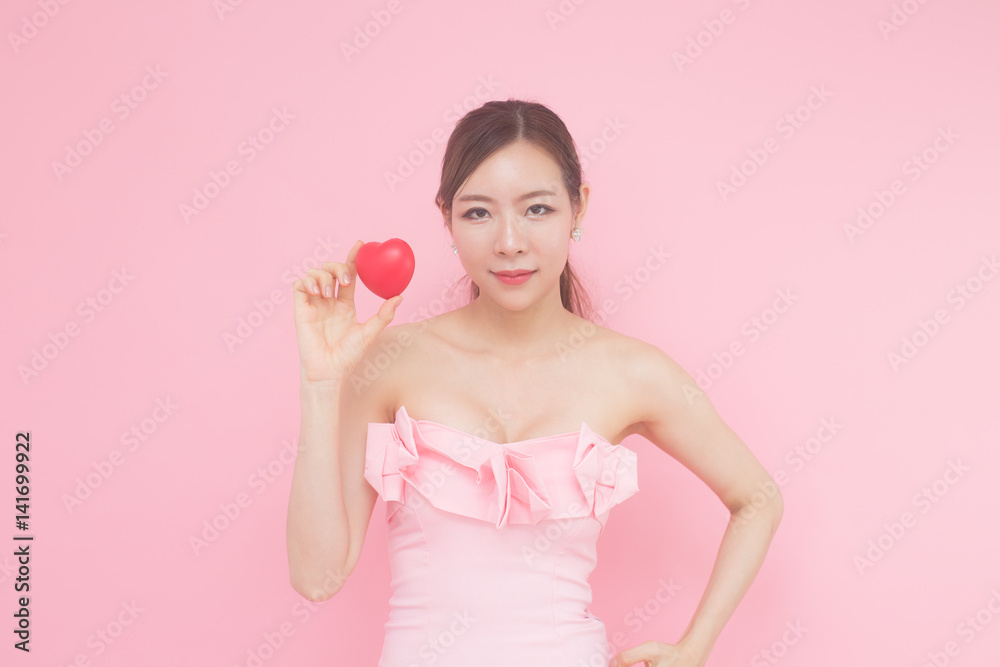 Beautiful asian woman holding with heart, isolated with pink background. Beautiful asian woman holding with heart, isolated with pink background.