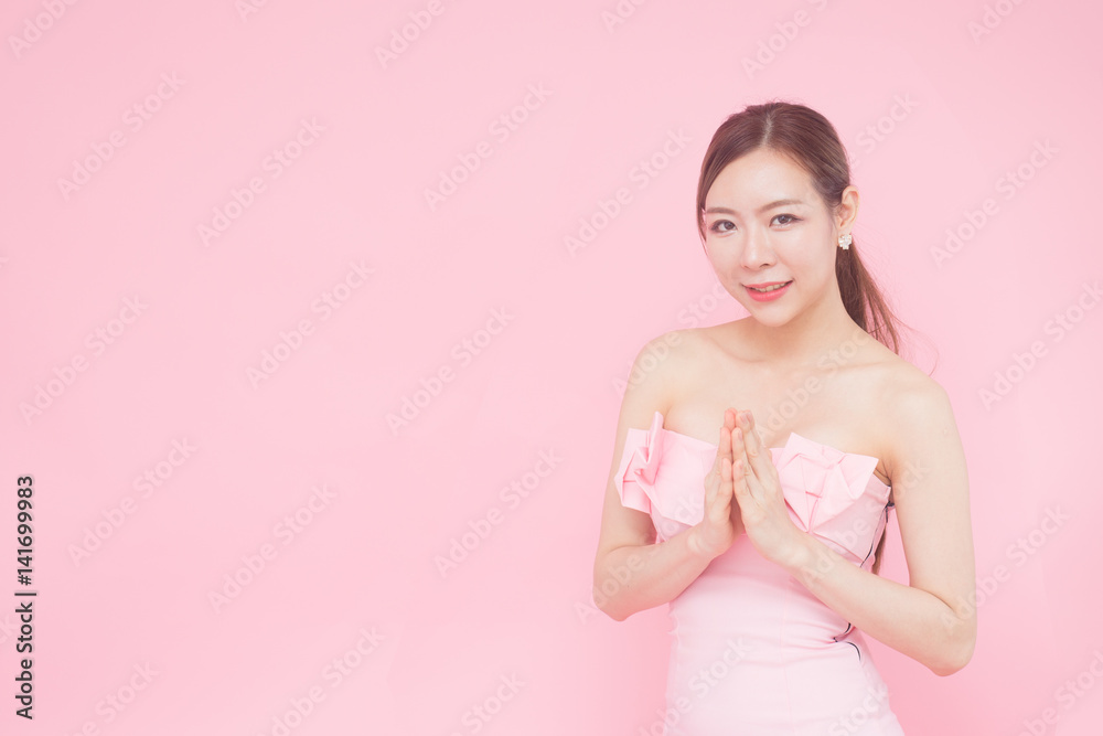 Beautiful young Asian woman with gesture of congratulation, isolated with pink background. Beautiful young Asian woman with gesture of congratulation, isolated with pink background.