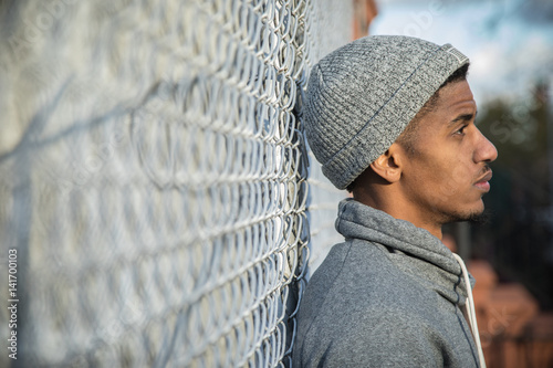 A young, black hipster poses for a candid photograph in NYC
