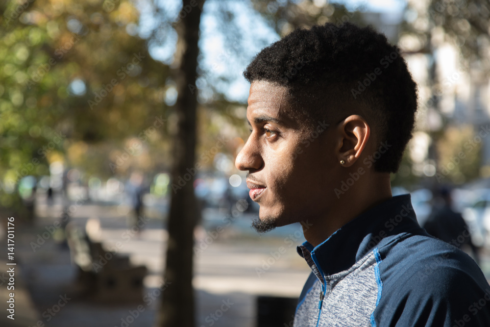 Portrait of a pensive, young black man in the city - NYC Portrait of a pensive, young black man in the city - NYC