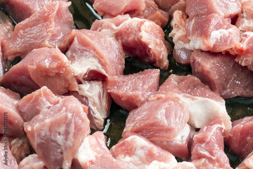 Row meat chops in cast iron skillet Row meat chops in cast iron skillet