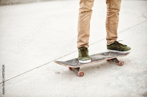 Close-up of skateboarders foot while skating in skate park