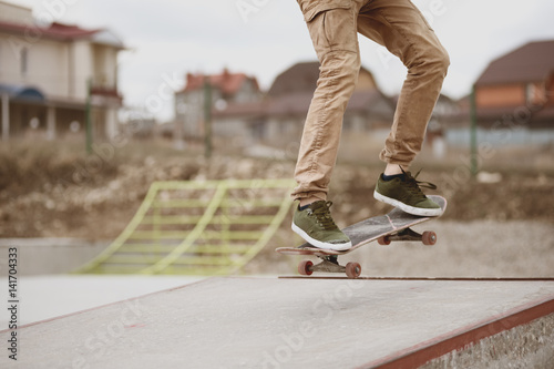 Close-up of skateboarders foot while skating in skate park © yanik88