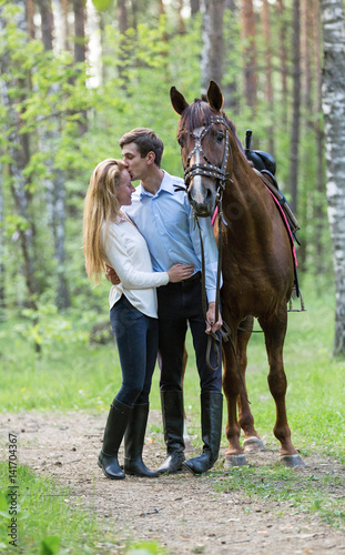 Young couple enjoying horseback riding. 
