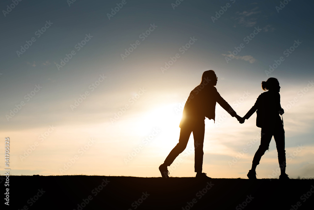 Couple of lover holding hand at sunset