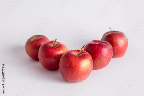 Red and green apples on a white background