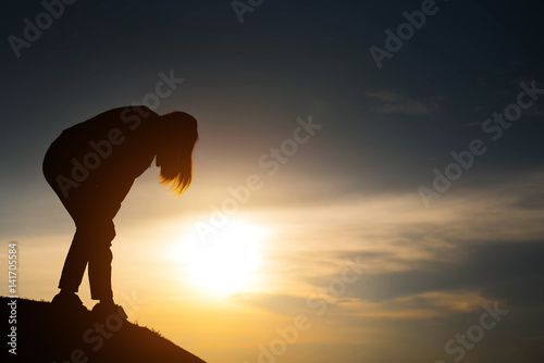 silhouette of woman Looking for a concept at sunset