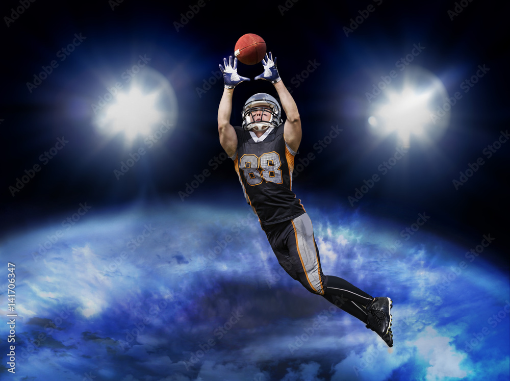 Fototapeta premium American football player catching ball