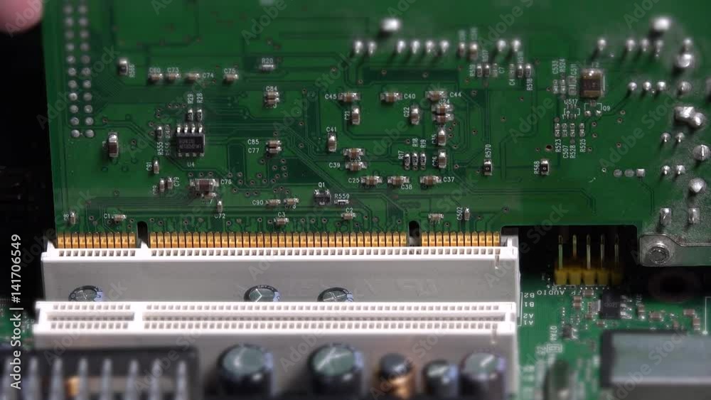 Hand insert pci card into motherboard slot on desktop computer Hand insert pci card into motherboard slot on desktop computer