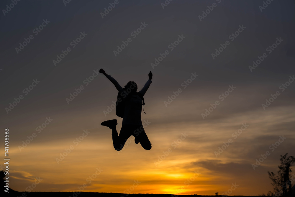Silhouette woman jumping at sunset Silhouette woman jumping at sunset
