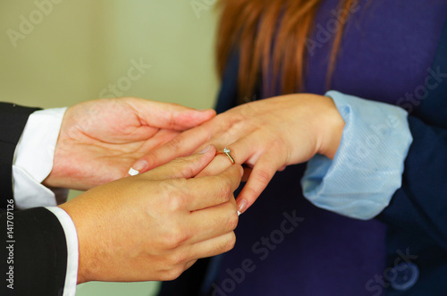 Close up shot of man putting ring on woman  s finger