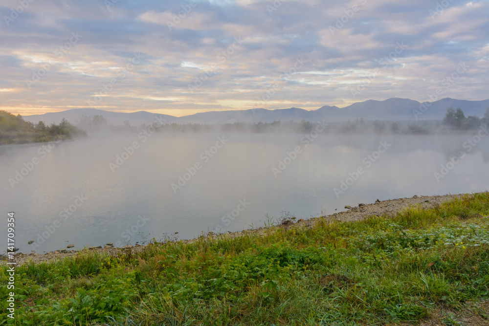 Lake in the mountains for recreation and fishing. Early morning Lake in the mountains for recreation and fishing. Early morning