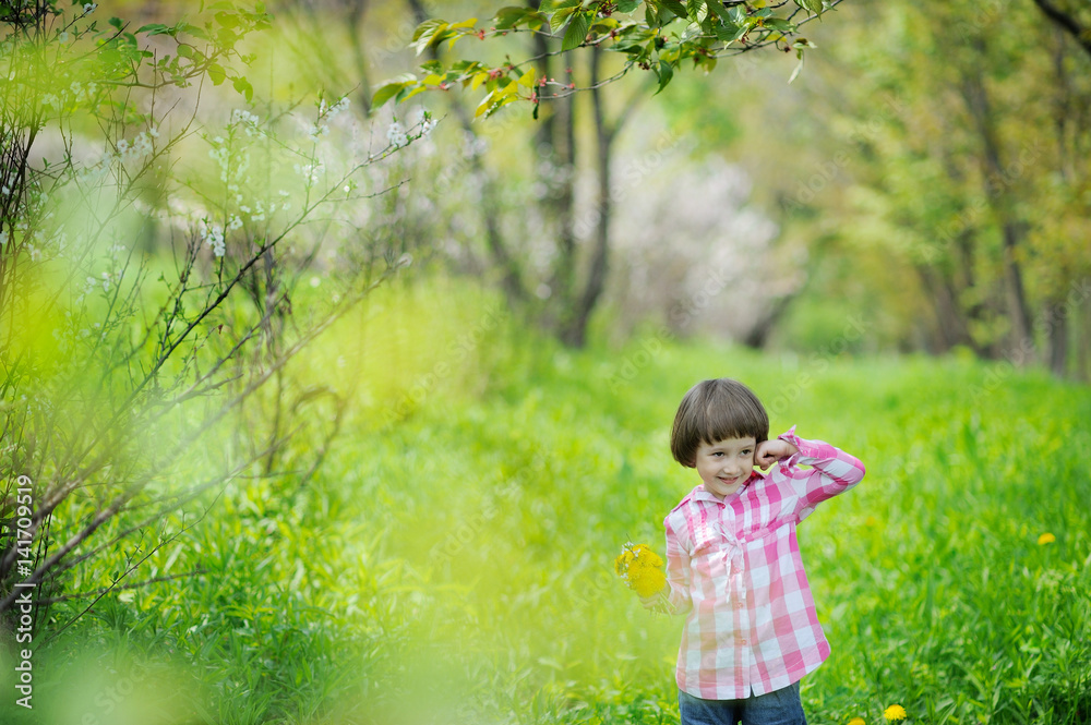 Cute little girl having fun in blooming cherry garden on beautiful spring day Cute little girl having fun in blooming cherry garden on beautiful spring day