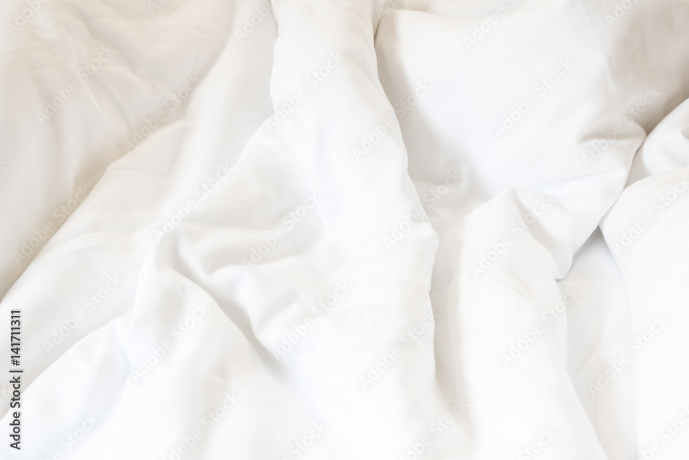 white pillow on bed and with wrinkle messy blanket in bedroom, from sleeping in a long night.