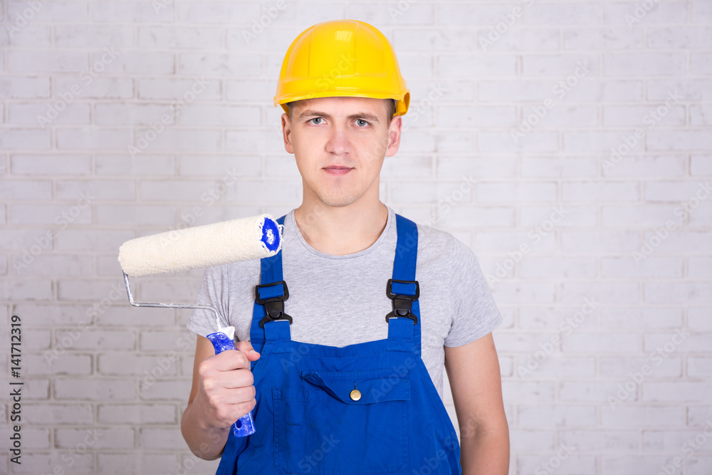 Portrait Of Man Painter In Workwear With Roller Paintbrush Over White portrait-of-man-painter-in-workwear-with-roller-paintbrush-over-white